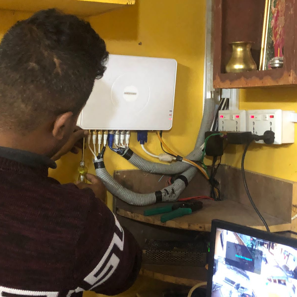 CCTV Security Installation: Staff Installing DVR and plugging camera cables